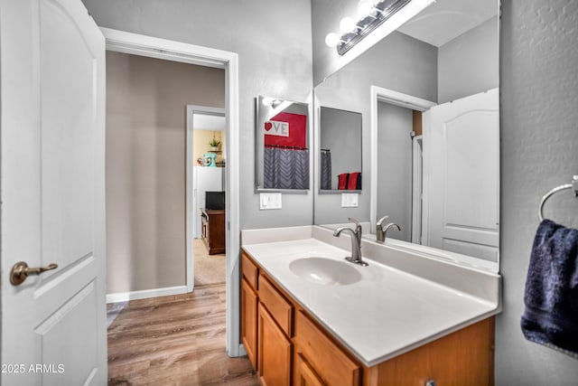 21604 E Calle De Flores, Queen Creek, AZ 85142 - bathroom featuring baseboards, wood finished floors, and vanity