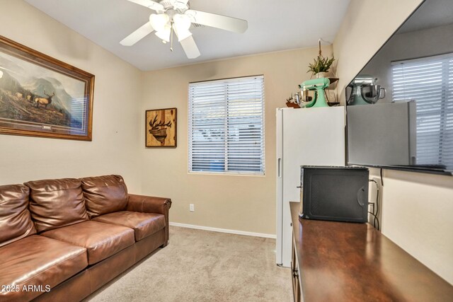 21604 E Calle De Flores, Queen Creek, AZ 85142 - carpeted living room featuring a healthy amount of sunlight, baseboards, and a ceiling fan