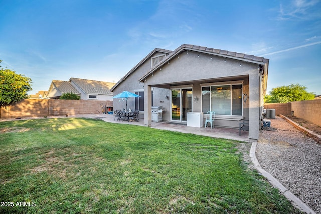 21604 E Calle De Flores, Queen Creek, AZ 85142 - back of property with a fenced backyard, a patio, stucco siding, and a lawn