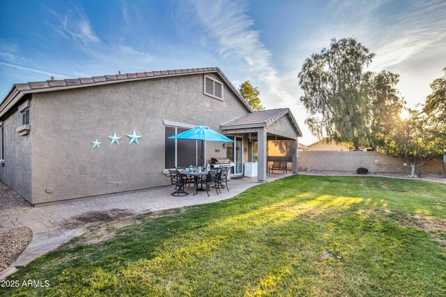 21604 E Calle De Flores, Queen Creek, AZ 85142 - rear view of house with stucco siding, fence, a lawn, and a patio