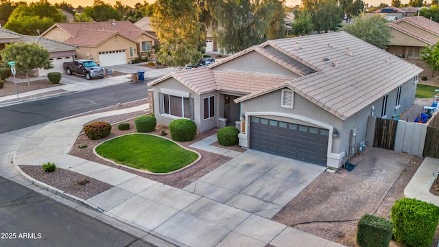21604 E Calle De Flores, Queen Creek, AZ 85142 - view of front of property featuring a tile roof, concrete driveway, stucco siding, fence, and an attached garage