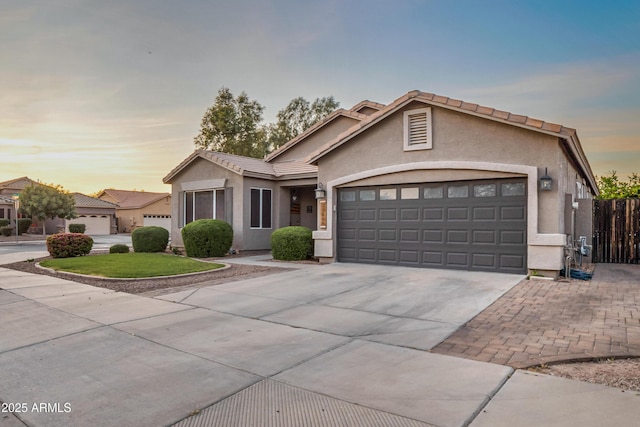 21604 E Calle De Flores, Queen Creek, AZ 85142 - ranch-style home with stucco siding, fence, a tiled roof, driveway, and a garage