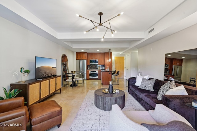 living room with arched walkways, a chandelier, visible vents, and recessed lighting