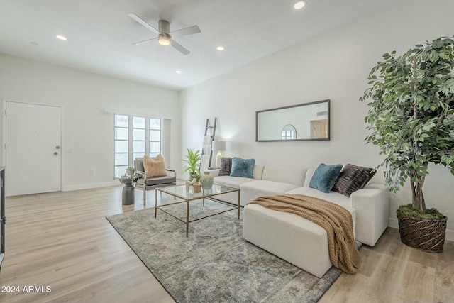 living room with ceiling fan and light wood-type flooring