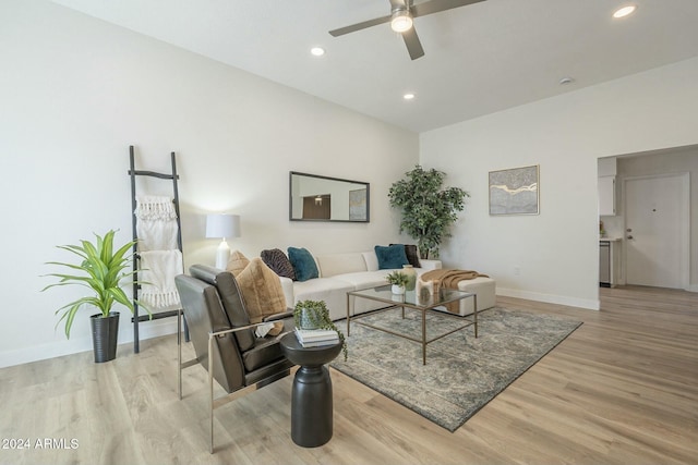 living room featuring light hardwood / wood-style flooring and ceiling fan