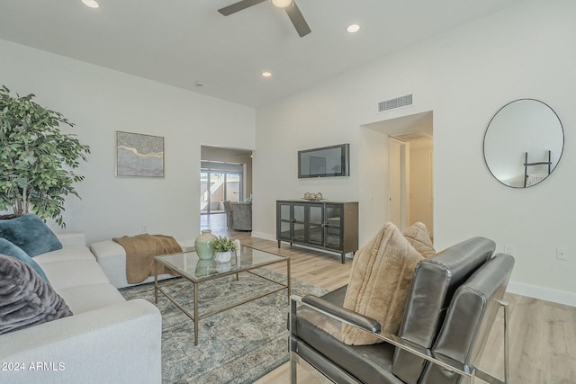 living room featuring ceiling fan and light hardwood / wood-style flooring