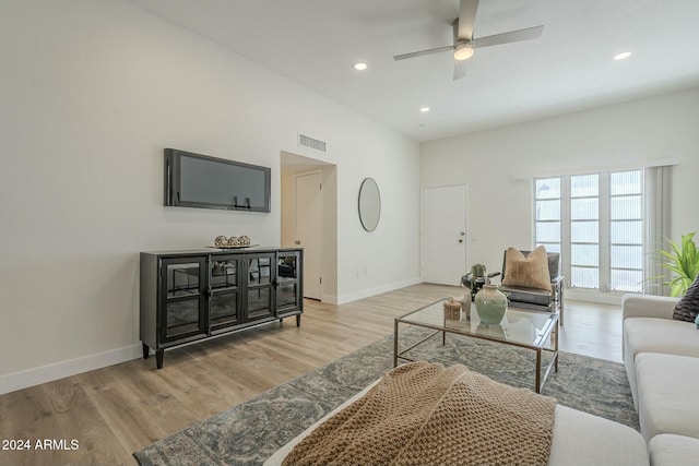 living room with ceiling fan and light hardwood / wood-style flooring