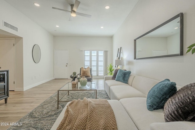 living room with ceiling fan and light hardwood / wood-style floors