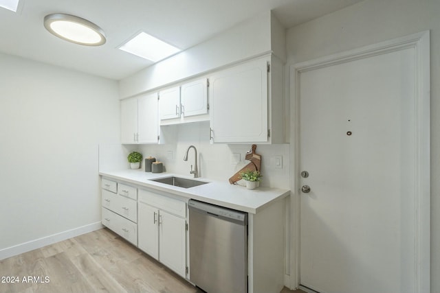 kitchen featuring sink, stainless steel dishwasher, tasteful backsplash, light hardwood / wood-style floors, and white cabinetry