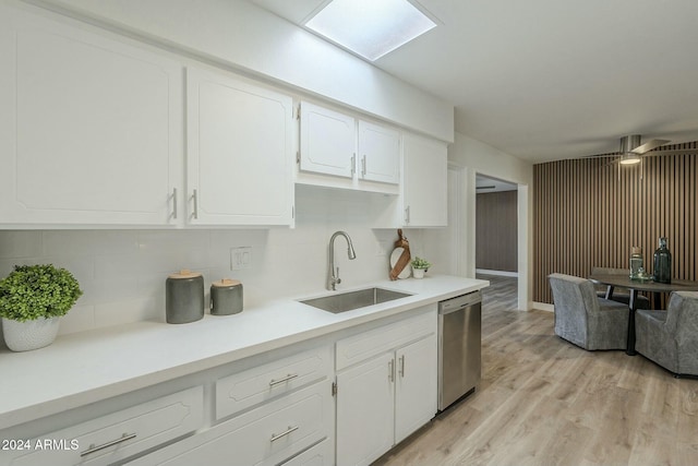 kitchen with white cabinets, tasteful backsplash, sink, dishwasher, and light hardwood / wood-style floors