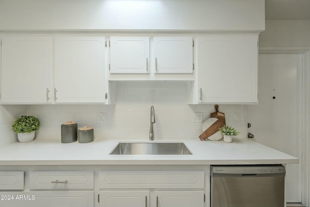 kitchen with backsplash, dishwasher, white cabinets, and sink