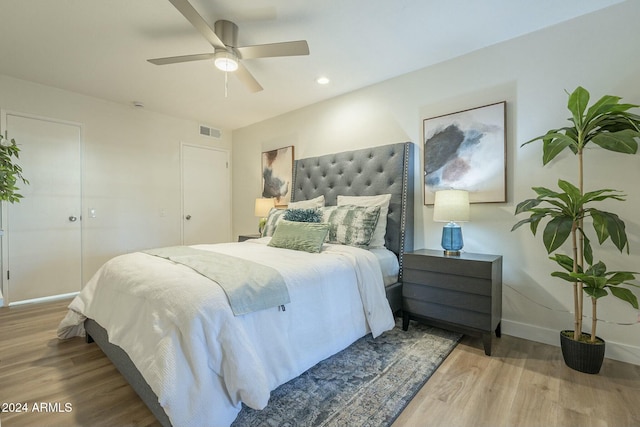 bedroom featuring wood-type flooring, a closet, and ceiling fan