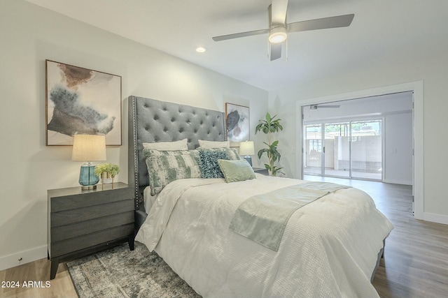 bedroom featuring hardwood / wood-style floors, ceiling fan, and access to exterior