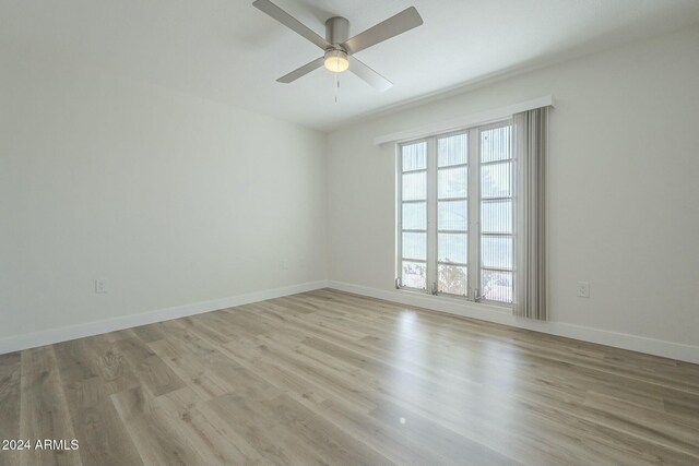 empty room featuring ceiling fan and light hardwood / wood-style flooring