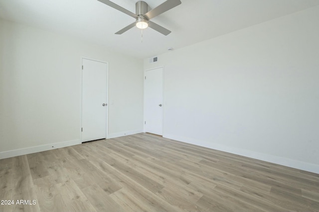 spare room featuring ceiling fan and light hardwood / wood-style flooring