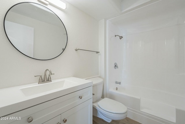 full bathroom featuring vanity, hardwood / wood-style flooring, toilet, and shower / washtub combination