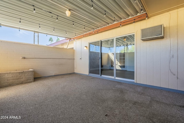 view of patio with a wall unit AC