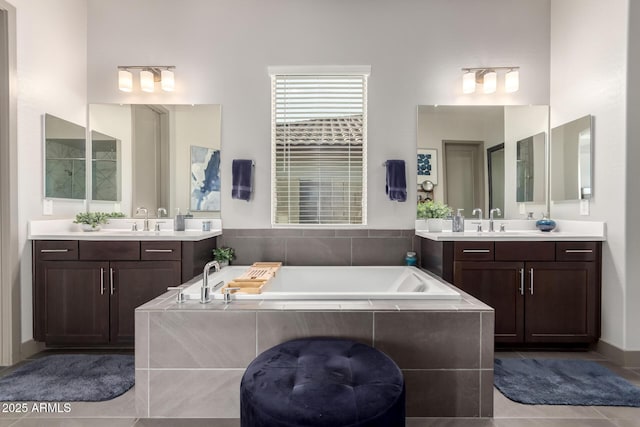 bathroom with a sink, two vanities, and a bath