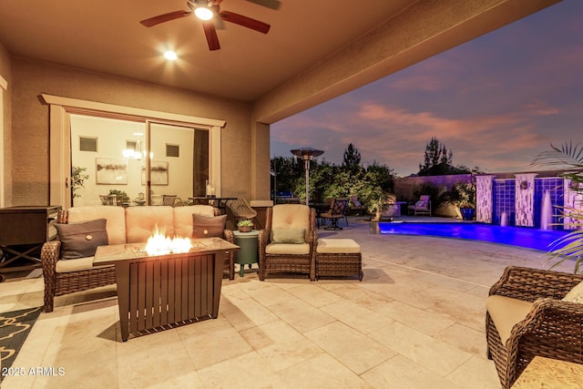 view of patio / terrace with an outdoor living space with a fire pit, an outdoor pool, and ceiling fan