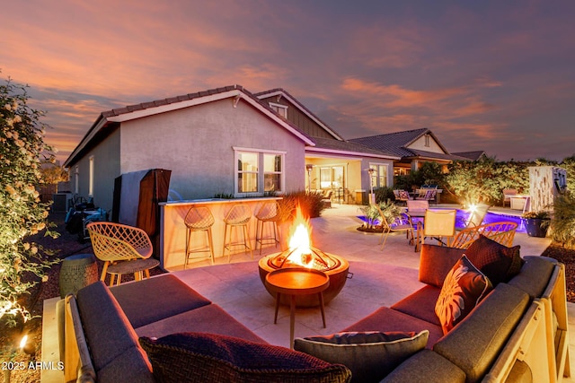 view of patio / terrace featuring an outdoor living space with a fire pit