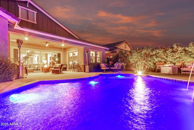 outdoor pool with ceiling fan, an outdoor living space, and a patio area