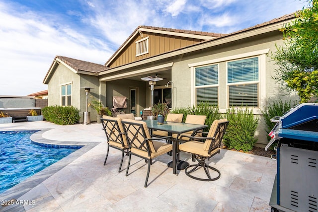 view of patio featuring a hot tub, outdoor dining area, and a fenced in pool
