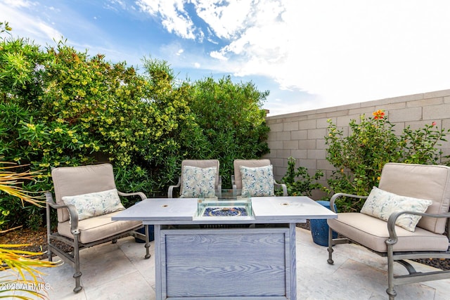 view of patio with a fire pit and fence