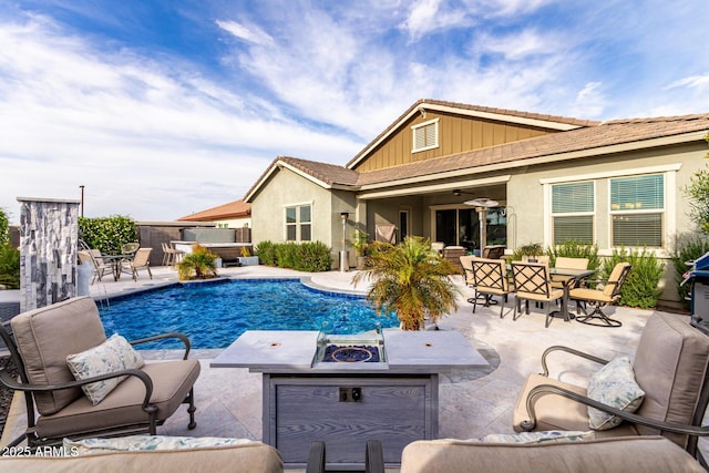 view of swimming pool with an outdoor living space with a fire pit, outdoor dining area, a ceiling fan, a jacuzzi, and a patio area