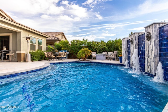 pool featuring an outdoor living space and a patio area