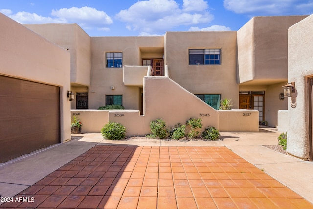 pueblo-style house with a garage