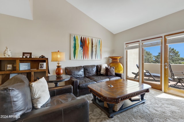 living room featuring plenty of natural light, carpet flooring, and high vaulted ceiling