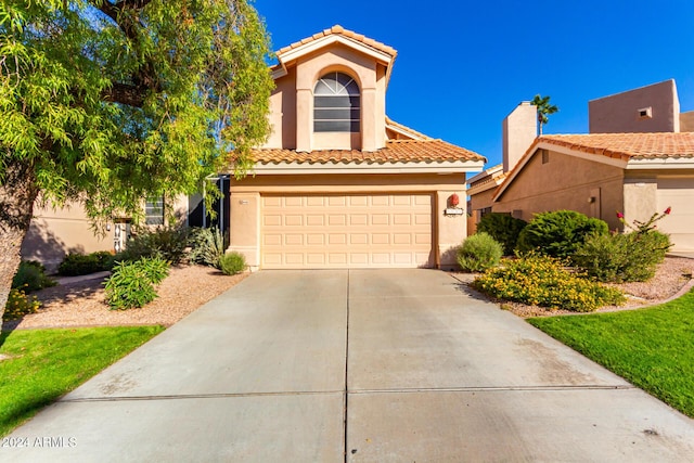 mediterranean / spanish house featuring a garage