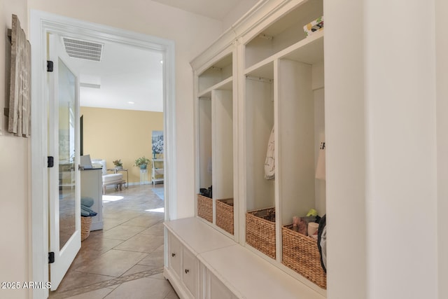 mudroom with light tile patterned floors