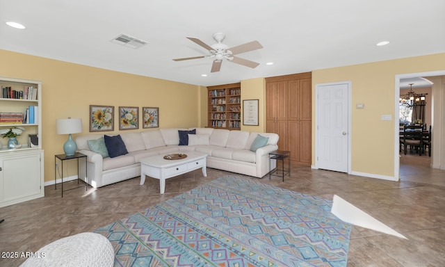 tiled living room with built in features and ceiling fan with notable chandelier