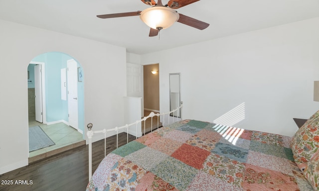 bedroom with dark hardwood / wood-style flooring and ceiling fan