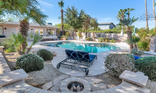 view of swimming pool featuring a patio area and an outdoor fire pit