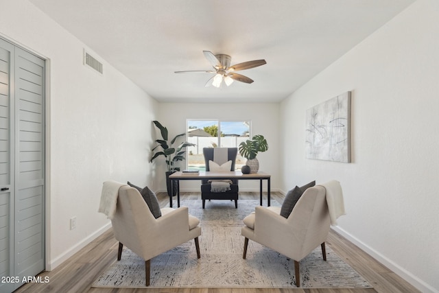 office with hardwood / wood-style flooring and ceiling fan