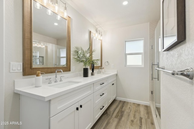 bathroom with vanity, wood-type flooring, and a shower with shower door