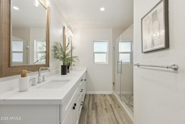 bathroom with vanity, hardwood / wood-style floors, and an enclosed shower