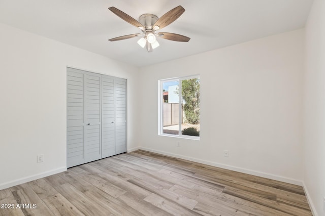 unfurnished bedroom with a closet, ceiling fan, and light wood-type flooring