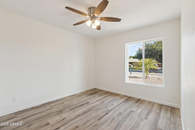 spare room featuring ceiling fan and light hardwood / wood-style flooring