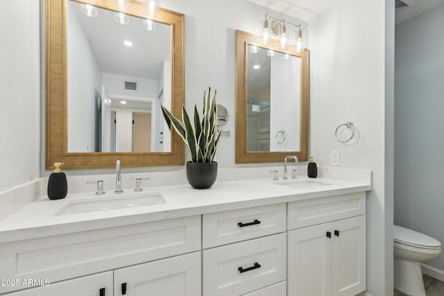 bathroom featuring vanity and toilet