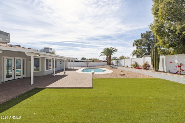 view of swimming pool featuring french doors, central air condition unit, a patio area, and a lawn