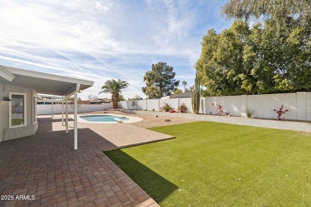 view of yard featuring a fenced in pool and a patio