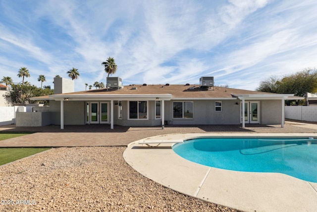 view of swimming pool featuring french doors, a patio, and cooling unit