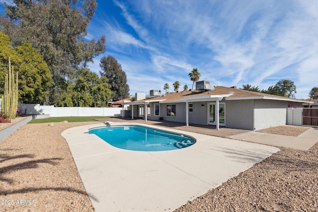 view of swimming pool with central AC unit, a patio area, and a diving board