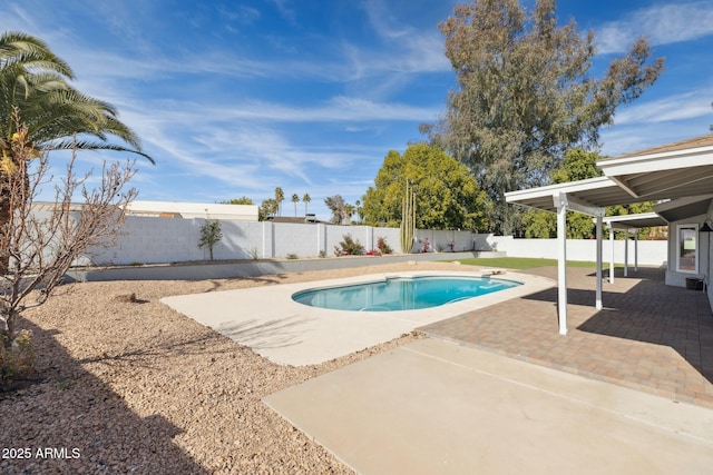 view of swimming pool with a diving board and a patio area