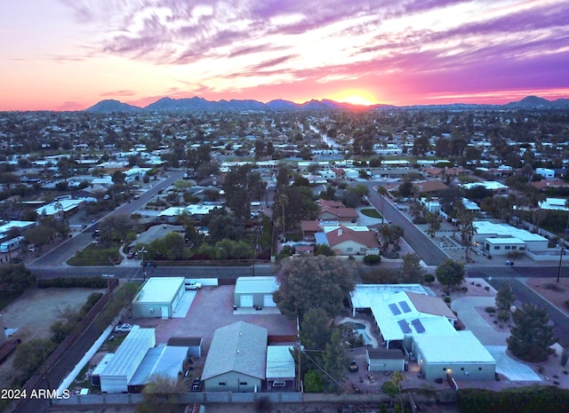 aerial view at dusk featuring a mountain view