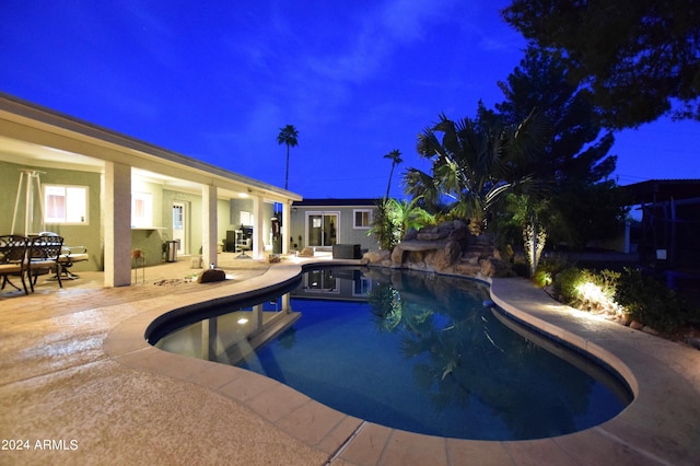 pool at night with a patio