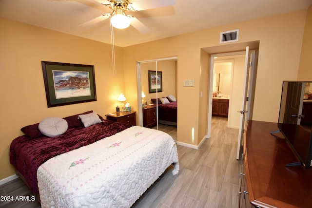 bedroom with hardwood / wood-style flooring, a closet, and ceiling fan